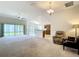 Spacious living room with sliding glass doors leading to the outdoor area and open layout to the kitchen at 2992 Hicks Pl, The Villages, FL 32163