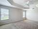Spacious main bedroom featuring neutral walls, carpet flooring, and a ceiling fan at 2992 Hicks Pl, The Villages, FL 32163
