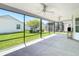 View of the screened patio with ceiling fans and spacious layout overlooking the backyard and adjacent homes at 2992 Hicks Pl, The Villages, FL 32163