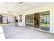 View from screened patio showing ceiling fans, tile floor, and sliding glass doors into the home at 2992 Hicks Pl, The Villages, FL 32163