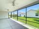 The screened in patio has ceiling fans and unobstructed views of the lush back lawn at 2992 Hicks Pl, The Villages, FL 32163
