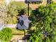 Aerial view showcasing a home with a well-manicured lawn, mature trees, and a driveway in a residential area at 301 Brookstone Ln, Fruitland Park, FL 34731