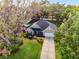 Aerial view of a single Gathering home with a driveway and lush landscaping in a desirable neighborhood at 301 Brookstone Ln, Fruitland Park, FL 34731