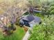 Aerial view of a well-maintained single-Gathering home with landscaped yard and mature trees on a spacious lot at 301 Brookstone Ln, Fruitland Park, FL 34731