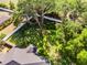 Aerial view of backyard enclosed by a white fence, with mature trees providing shade and privacy at 301 Brookstone Ln, Fruitland Park, FL 34731