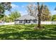 Well-manicured backyard with a large lawn, mature shade trees, and privacy fencing at 301 Brookstone Ln, Fruitland Park, FL 34731
