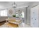 Bright dining area features stylish light fixture, hutch, and sliding glass doors to screened porch at 301 Brookstone Ln, Fruitland Park, FL 34731