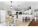 Open kitchen and dining area with breakfast bar seating and modern black appliances at 301 Brookstone Ln, Fruitland Park, FL 34731