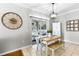 Open dining area with access to the screened in patio, stylish hutch and wall decor at 301 Brookstone Ln, Fruitland Park, FL 34731
