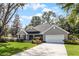 Well-maintained one-story home with an attached garage, manicured lawn, and tasteful landscaping at 301 Brookstone Ln, Fruitland Park, FL 34731