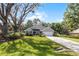 Beautiful one-story home with a large front yard, mature trees, and a paved driveway at 301 Brookstone Ln, Fruitland Park, FL 34731