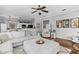 Bright living room with hardwood floors, large sectional sofa and view into dining area at 301 Brookstone Ln, Fruitland Park, FL 34731