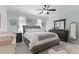 Relaxing main bedroom featuring soft, natural light, ceiling fan, and ensuite at 301 Brookstone Ln, Fruitland Park, FL 34731