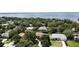 An aerial view featuring mature trees with partial views of single-story homes near a large lake at 3030 Brighton Rd, Eustis, FL 32726