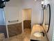 Bathroom with double vanity, tile floors and tile backsplash at 3030 Brighton Rd, Eustis, FL 32726
