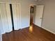 Bedroom interior with hardwood flooring and bi-fold closet at 3030 Brighton Rd, Eustis, FL 32726