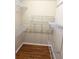 Walk-in closet featuring hardwood floors and wire shelving units at 3030 Brighton Rd, Eustis, FL 32726