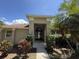 Charming front entrance featuring a decorative door, manicured shrubs, and a well-lit walkway at 3030 Brighton Rd, Eustis, FL 32726