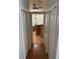 Hallway view leading to a bathroom with travertine floors and backsplash at 3030 Brighton Rd, Eustis, FL 32726
