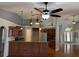 Open-concept kitchen with a breakfast bar, stainless steel appliances, and hardwood floors at 3030 Brighton Rd, Eustis, FL 32726
