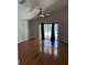 Spacious living room featuring hardwood floors and sliding glass doors to the pool area at 3030 Brighton Rd, Eustis, FL 32726