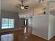 A spacious living area with hardwood floors and a view of the outdoor pool through a large window at 3030 Brighton Rd, Eustis, FL 32726