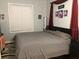 Serene primary bedroom features a large bed, dark furniture, and soft, natural lighting at 312 North Blvd W, Davenport, FL 33837