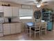 Cozy dining area with white cabinets and seating for four by a window at 312 North Blvd W, Davenport, FL 33837
