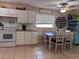 Bright kitchen with white cabinets, butcher block countertops, and a cozy dining area at 312 North Blvd W, Davenport, FL 33837