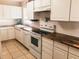 Bright kitchen featuring white cabinetry, wooden countertops, and modern appliances at 312 North Blvd W, Davenport, FL 33837