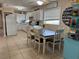 Bright kitchen and dining area featuring white cabinets, dining table, and ample natural light at 312 North Blvd W, Davenport, FL 33837