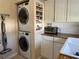 Laundry area with stacked washer and dryer, a built-in spice rack, and butcher block countertop at 312 North Blvd W, Davenport, FL 33837