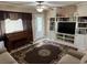 Well lit living room boasts built-in shelving, a piano, and a comfortable seating area at 312 North Blvd W, Davenport, FL 33837