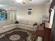 Comfortable living room with sectional sofa, rug, and decorative wall accents at 312 North Blvd W, Davenport, FL 33837