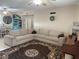 Comfortable living room with sectional sofa, rug, and decorative wall accents at 312 North Blvd W, Davenport, FL 33837