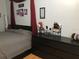 Comfortable primary bedroom featuring a dark dresser, red lamps and gray linens at 312 North Blvd W, Davenport, FL 33837
