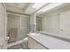 Bathroom showcasing shower, neutral tile and vanity offering functionality and storage space at 35138 Silver Oak Dr, Leesburg, FL 34788