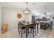 Inviting dining area with modern lighting and a view of the kitchen's island and stainless steel appliances at 35138 Silver Oak Dr, Leesburg, FL 34788
