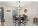 Bright dining room with tiled floors, a dark wood dining table, and modern chandelier at 35138 Silver Oak Dr, Leesburg, FL 34788