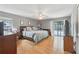Spacious main bedroom with hardwood floors and access to a screened-in lanai and pool area at 35138 Silver Oak Dr, Leesburg, FL 34788