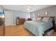 Well-lit main bedroom with hardwood floors, a ceiling fan, and a comfortable king-size bed at 35138 Silver Oak Dr, Leesburg, FL 34788