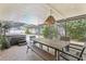 Covered patio with dining area, fan, view of pool, and outdoor space for entertaining at 35138 Silver Oak Dr, Leesburg, FL 34788