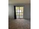 Living room view through the sliding glass doors to the balcony with beautiful landscaping and palm trees at 3748 Idlebrook Cir # 202, Casselberry, FL 32707