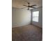 Cozy bedroom with neutral carpet, ceiling fan, and a window letting in natural light at 3748 Idlebrook Cir # 202, Casselberry, FL 32707