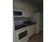 Close up shot of functional kitchen featuring white appliances, tile flooring, and ample counter space at 3748 Idlebrook Cir # 202, Casselberry, FL 32707