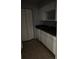 Bright kitchen with white cabinets, tiled floor, and a double sink at 3748 Idlebrook Cir # 202, Casselberry, FL 32707
