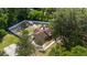 Aerial view of a property with a fenced backyard, storage shed, and mature trees providing shade at 400 Sw 35Th St, Ocala, FL 34471