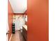 Cozy bathroom featuring warm orange walls, a floral shower curtain, and a single sink vanity at 400 Sw 35Th St, Ocala, FL 34471