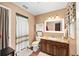 Classic bathroom featuring a shower-tub combination, vanity with a mirror, and ceramic tile flooring at 400 Sw 35Th St, Ocala, FL 34471