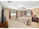 Cozy bedroom featuring neutral colors, natural light, and a ceiling fan at 400 Sw 35Th St, Ocala, FL 34471